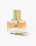 A bottle of Viktor & Rolf Vuitton Oblique Eau de Parfum with amber-colored liquid in a clear glass bottle, featuring a gold cap and base, and a gold hanging tag with the brand name.