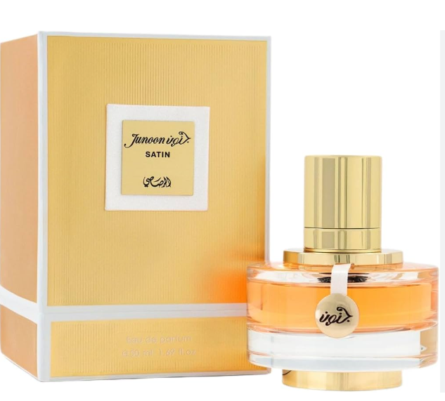 Junoon Satin perfume bottle with a gold cap next to its yellow and white textured box, on a white background.