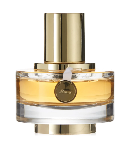 A bottle of Persol perfume with a gold cylindrical cap, a clear glass body showing amber liquid inside, and a round gold Persol logo medallion on the front, set against a plain white background.
