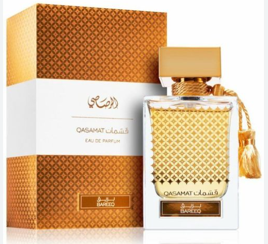 Qasamat Bareeto Eau de Parfum bottle with a gold patterned cap and neck, shown next to its matching orange and white patterned box.