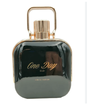 A bottle of One Day Old Eau de Parfum with a glossy black body and gold accents, including a gold cap and handle, on a white background.