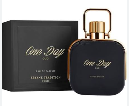 A bottle of Revye Tradition 'One Day Oud' Eau de Parfum with its black packaging box, featuring a dark navy blue bottle and gold accents.
