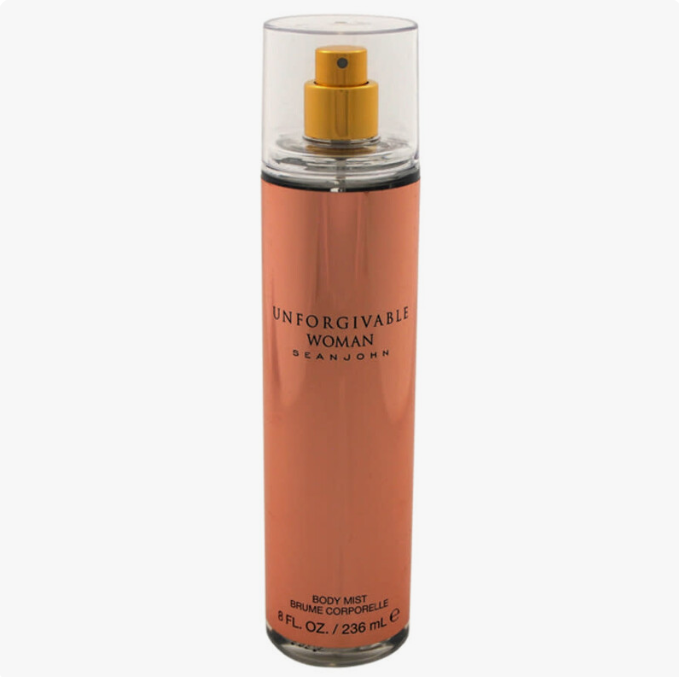 A bottle of Dean John Unforgivable Woman Body Mist in a peach-colored cylindrical bottle with a gold spray top and a clear cap, shown on a light gray background.