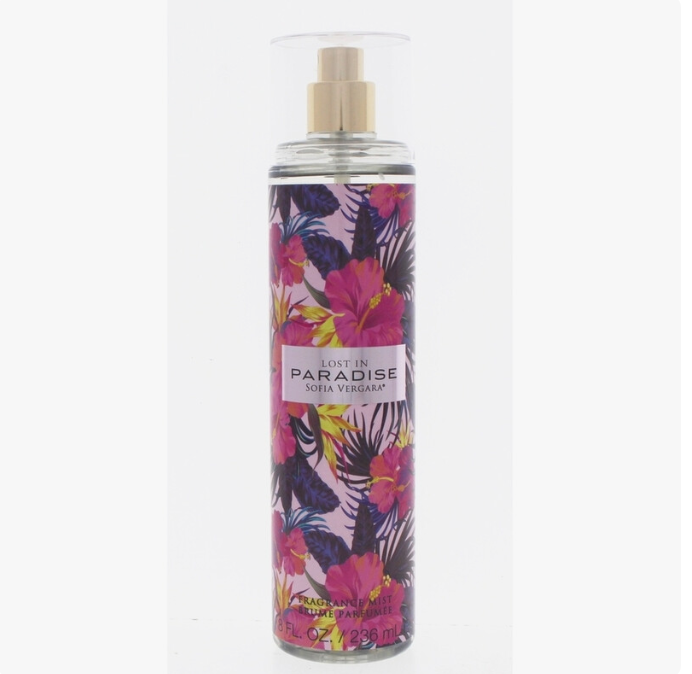 A bottle of Sofia Vergaro 'Lost in Paradise' Eau de Parfum spray, featuring a vibrant tropical floral pattern with pink hibiscus flowers and dark palm leaves on a light lavender background. The bottle has a clear cap and a gold spray nozzle.