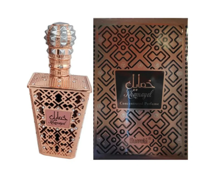 A perfume bottle and its matching box, both decorated with an intricate geometric pattern in metallic bronze and black, with the brand name Surrati visible near the bottom.