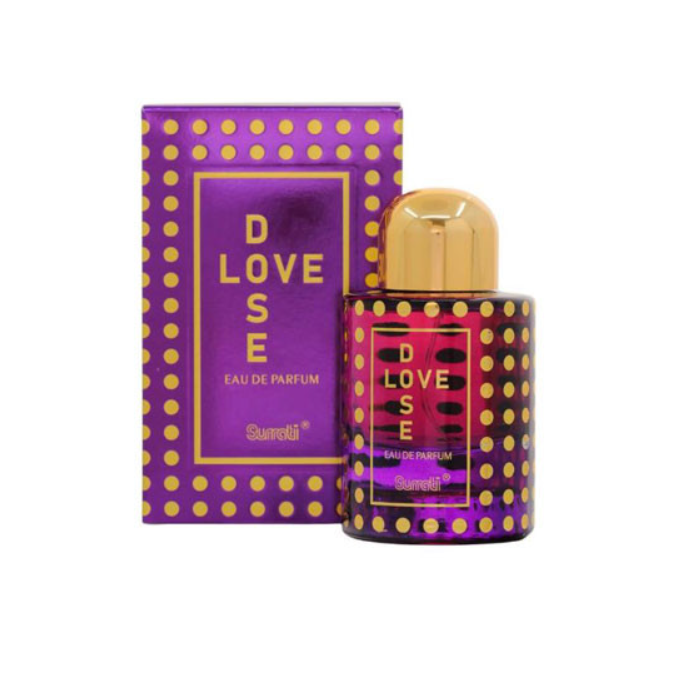 A bottle of Suratti Love Dose Eau de Parfum next to its purple and gold polka-dot box packaging, set against a plain white background.