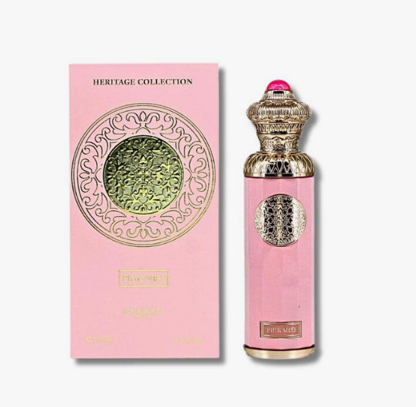 Pink perfume bottle and its matching pink packaging box from Heritage Collection, featuring ornate gold detailing and a pink cap, on a light gray background.
