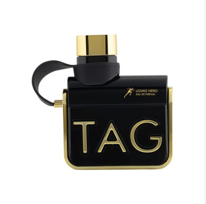 TAG Uomo Nero Eau de Parfum bottle, featuring a black rectangular body with gold trim, gold 'TAG' lettering, and a black wrist strap, set against a plain white background.