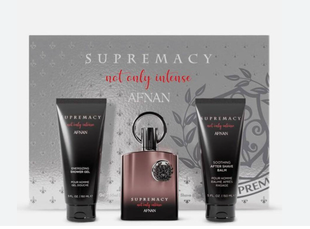 AFNAN Supremacy 'not only intense' fragrance gift set featuring a central dark amber bottle with a silver ring handle, flanked by a black showering shower gel tube and a black soothing after massage balm tube, set against a gray patterned gift box.
