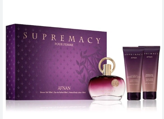 Afnan Supremacy Four Femme fragrance gift set featuring a purple box, a gradient perfume bottle with a gold cap, and two matching body care tubes on a white background.