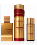 Al Haramain Amber Oud Ruby Edition fragrance set featuring a rectangular 75ml perfume bottle, a 300ml deodorant body spray canister, and a smaller 15ml body spray bottle, all in a luxurious gold and ruby red color scheme.