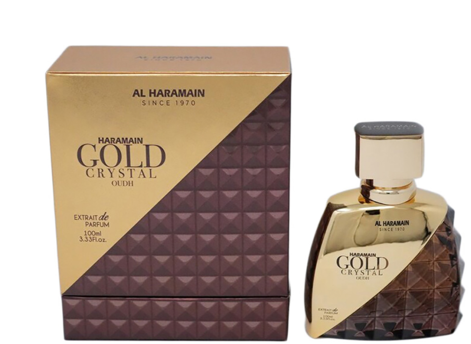 Al Haramain Gold Crystal Crush extrait de parfum 120ml bottle and its matching packaging box, featuring a metallic gold and dark purple geometric pattern.