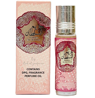 A bottle of ard al zaafaran hareem al sultan perfume oil next to its matching pink packaging box. The packaging features ornate red and gold Arabic calligraphy designs on a light pink background with subtle polka dots and swirl patterns.