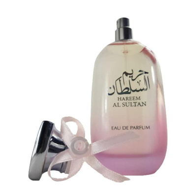 Hareem Al Sultan Eau de Parfum bottle with a pink gradient design, shown with its silver atomizer cap and a white ribbon bow on a white background.