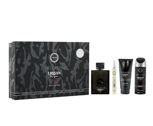 Urban Men Club de Nuit Aventus Set, featuring a black and gray patterned gift box alongside the travel set contents: a dark glass bottle, a small sample vial, a black tube, and a black shower gel bottle.