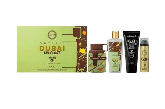 A Dubai Chocolate gourmand edition fragrance gift set featuring a light green and brown box, a brown bottle, a green bottle, a black tube, and a gold spray can on a white background.
