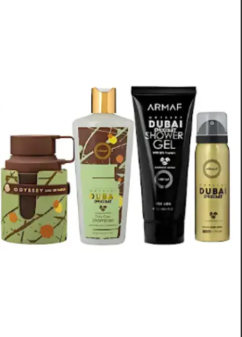 Four travel-sized toiletry products from Emirates SkyCargo displayed side-by-side on a plain white background: a green insulated tumbler with a brown lid, a frosted bottle with a gold cap, a black tube labeled ARMAF DUBAI SKYCARGO shower gel, and a gold aerosol can labeled DUBAI SKYCARGO.
