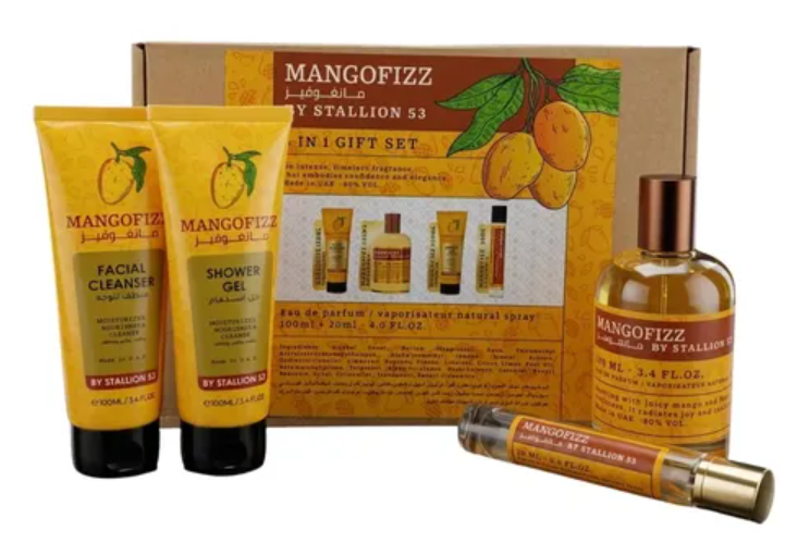 Mangofizz by Stallion 53 gift set featuring a facial cleanser tube, shower gel tube, a perfume bottle, a sample spray tube, and the branded gift box on a white background.