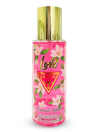 Guess Love Romantic Blush fragrance mist in a clear bottle with a shiny gold cap, featuring a pink floral label with cherry blossoms.