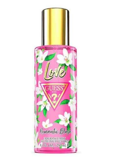 Guess Love Romantic Blush fragrance mist in a clear bottle with a pink floral label, white blossoms, green leaves, and a shiny gold cap, on a white background.