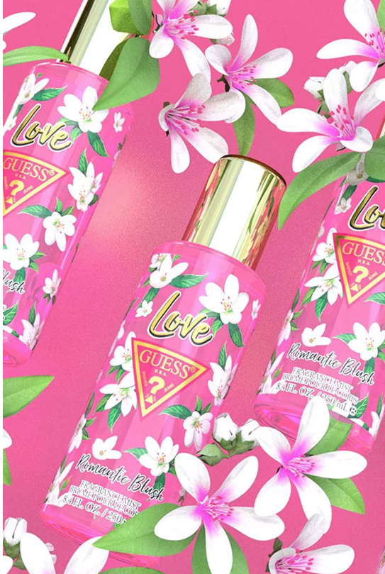 Guess perfume bottles with white floral prints and gold caps, arranged on a bright pink background with white flowers and green leaves.