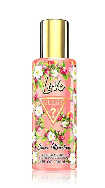 Guess Love Sheer Attraction fragrance mist in a clear bottle with pink liquid, white and pink floral illustrations, and a shiny gold cap on a white background.