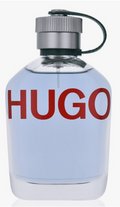 Hugo perfume bottle with a clear glass body, light blue liquid, a silver metal cap, and a dark green hanging loop, featuring the brand name 'HUGO' in bold red letters on the front.