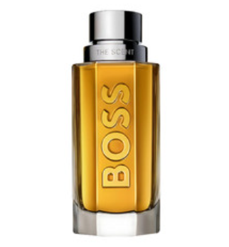 A bottle of Hugo Boss The Scent cologne with amber-yellow liquid inside a clear glass bottle, featuring a metallic silver cap and the brand name 'BOSS' printed vertically in gold on the front.