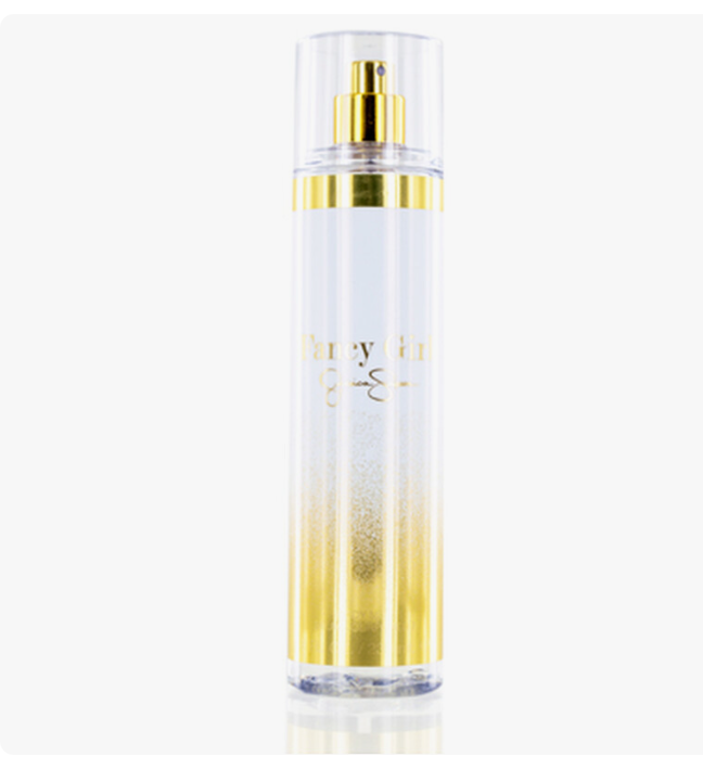 A clear cylindrical spray bottle with a gold pump and gold decorative band, featuring a white-to-gold gradient base and the text 'Fancy Girl' printed in gold on the front, set against a plain white background.