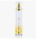 A clear cylindrical spray bottle with a gold pump and gold decorative band, featuring a white-to-gold gradient base and the text 'Fancy Girl' printed in gold on the front, set against a plain white background.