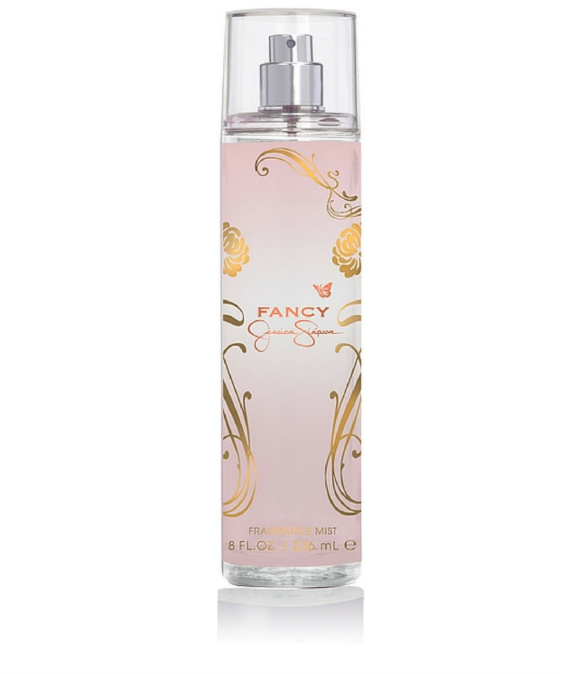 Fancy by Jennifer Savill fragrance mist in a clear cylindrical spray bottle with a silver pump and a pale pink label decorated with gold floral and scroll motifs.