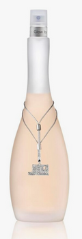 A bottle of J'Adore Glow Bright perfume spray with a frosted pale peach body, a white neck, and a silver pendant necklace design on the front.