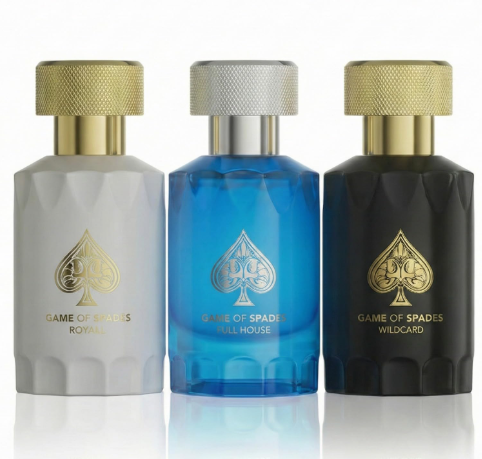 Three bottles of Poker Royalty by Poker Club arranged side by side on a white reflective surface. The left bottle is frosted white with a gold cap and gold text reading 'GAME OF SPADES ROYALTY'.