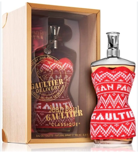 Jean Paul Gaultier Classique perfume bottle in a red knit sweater pattern, shown next to its light wood presentation box with a second bottle visible inside.