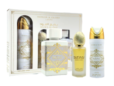 A fragrance gift set featuring a white and gold Honor & Glory Lailiyah box with three matching products: a cologne bottle, a perfume bottle, and a body spray bottle, all with ornate gold geometric designs on white and gold packaging.