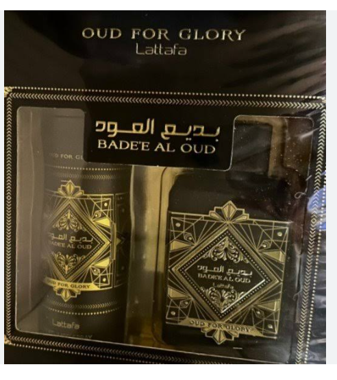 Lattafa Oud For Glory Bade' Al Oud gift set containing a cologne bottle and a matching body spray in a black box with gold detailing.