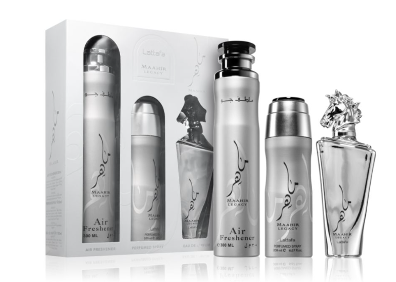 A perfume gift set featuring a white and silver Laalaa Maahir Legacy Air Freshener box and five matching glass bottles with silver caps, arranged on a reflective white surface.