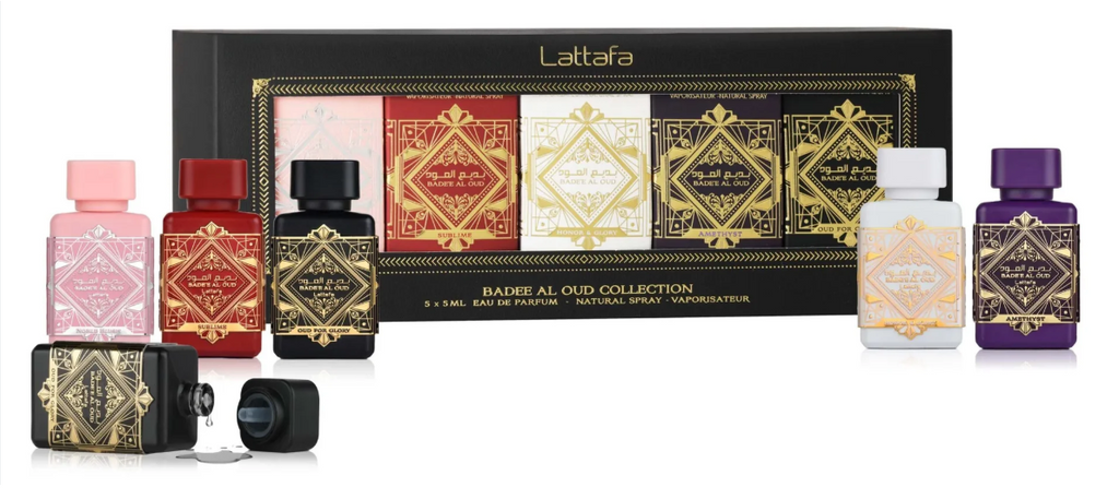 Lattaafa Barbe Al Old Collection gift set featuring six miniature perfume bottles in pink, red, black, white, beige, and purple with ornate gold labels, displayed in front of their black and gold presentation box.