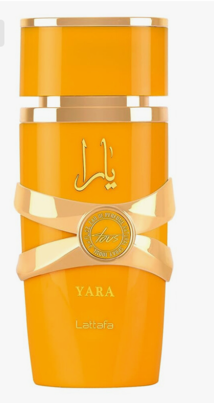 A bright orange cylindrical bottle with gold metallic accents, featuring Arabic calligraphy, a gold ribbon, and the text 'YARA' and 'Lattafa' on a white background.