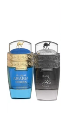 Two Le Coq Sportif Arabia Heroes cologne bottles side by side on a white background, one with a blue liquid and gold cap details, the other with a dark gray/black liquid and silver cap details.