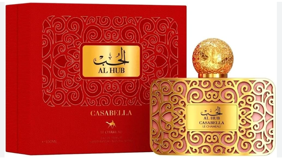 A bottle of Casabella Al Hub perfume with a gold filigree-patterned cap and matching gold label, shown next to its red presentation box with Arabic calligraphy and the brand name Casabella.