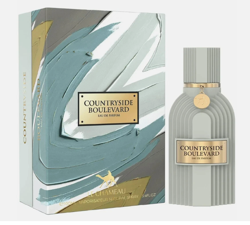 Countryside Boulevard Eau de Parfum bottle and its matching retail box. The bottle is a ribbed light gray with a gold label and cap, and the box features an abstract teal, gray, and gold paint stroke design.
