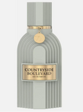 A ribbed light gray perfume bottle with a gold-toned label reading 'COUNTRYSIDE BOULEVARD EAU DE PARFUM' and a small hanging gold medallion, shown on a plain light gray background.