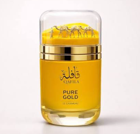 A bottle of Le Chambeau Qafila Pure Gold perfume with a transparent cap showing three gold camels, a yellow body, and gold accents, set against a plain white background.
