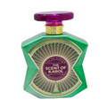 A green faceted perfume bottle with a purple cap and a gold and purple label reading 'THE SCENT OF KAROL' and 'EAU DE PARFUM'.