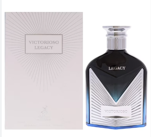 Victorioso Legacy fragrance shown with its pale pink box and the bottle itself. The bottle is dark blue-black with a silver faceted geometric design and a silver cap.