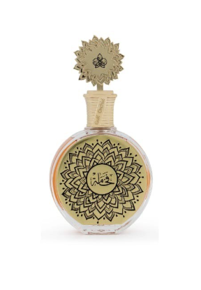 A round glass perfume bottle with a gold-toned lid and intricate black mandala-style patterns on the front, set against a plain white background.