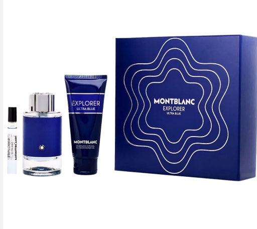Montblanc Explorer Ultra Blue fragrance gift set on a white background, including a blue perfume bottle, a blue body wash tube, and a small sample vial next to a blue gift box with white concentric line pattern.