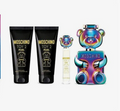 Moschino Toy 2 Pearl gift set featuring two black body wash tubes with gold lettering, a small clear spray bottle, and a large iridescent teddy bear-shaped perfume bottle on a white background.