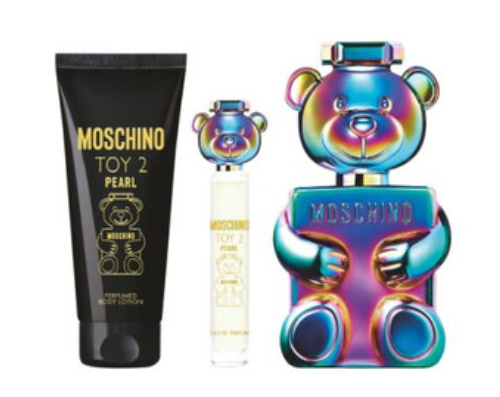 Moschino Toy 2 Pearls fragrance gift set featuring a black tube of body lotion with gold lettering, a small clear spray bottle, and a large iridescent bear-shaped perfume bottle on a white background.